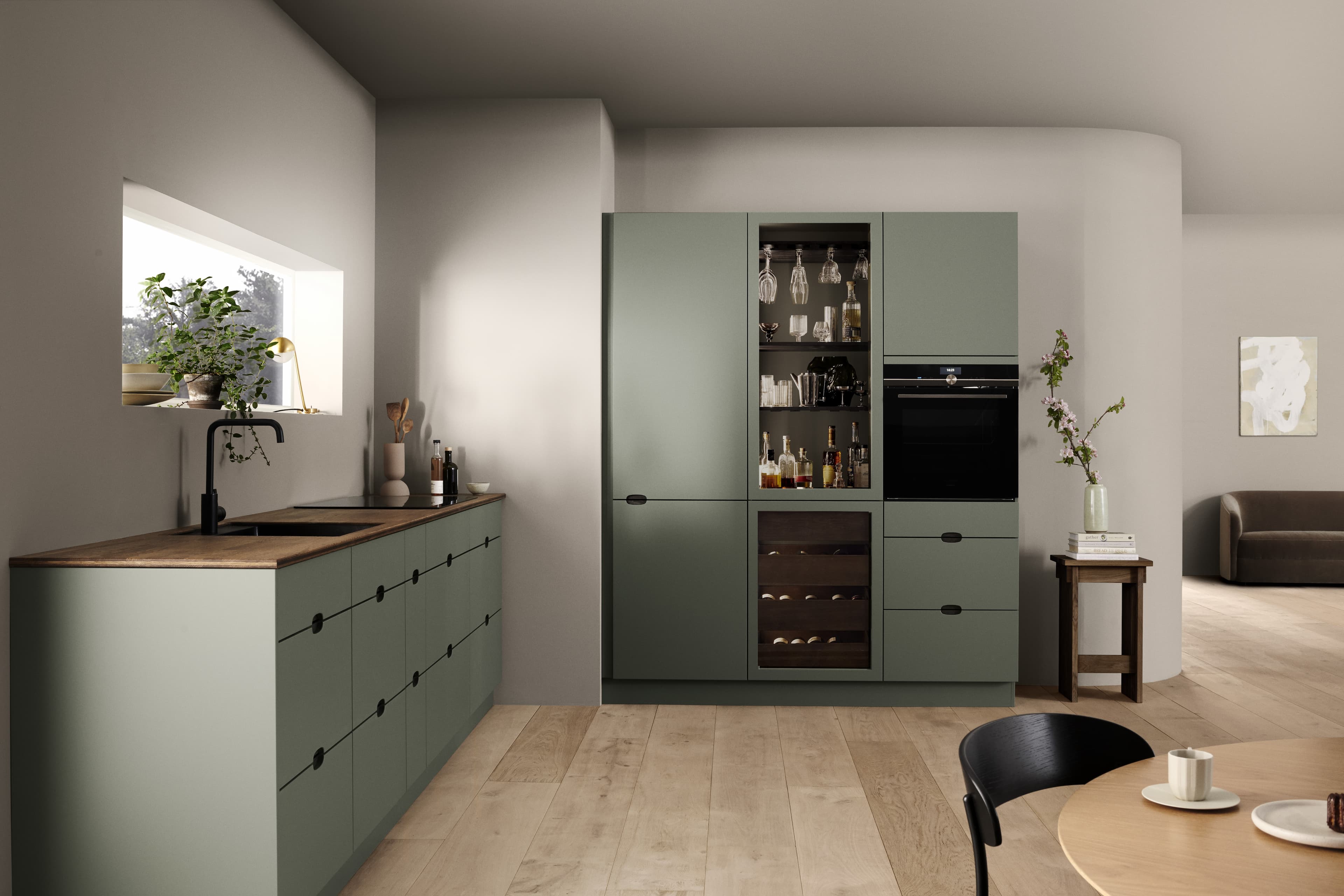 Green kitchen with a wine refrigerator and a wooden worktop